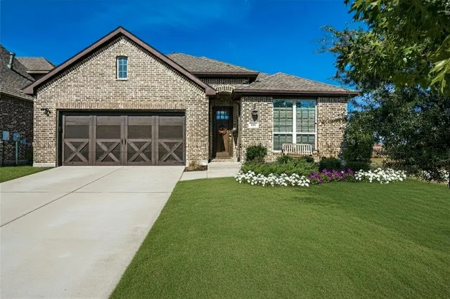 a front view of a house with a yard and porch