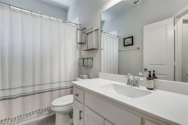 a bedroom with bed and a large window