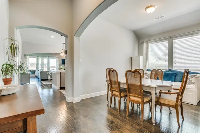 a view of a a dining room with furniture window and wooden floor
