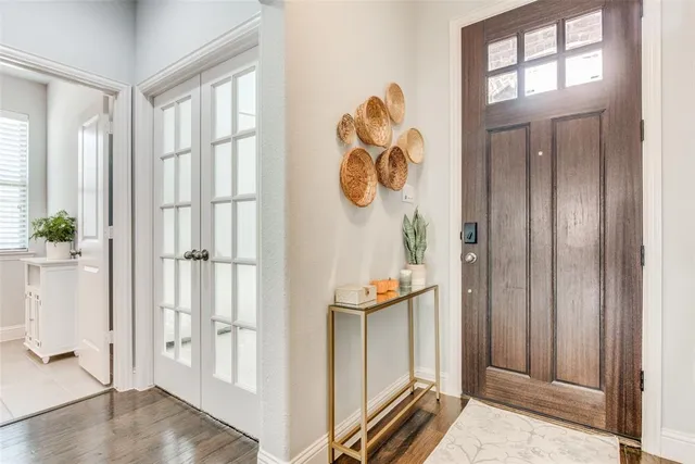 a view of a a dining room with furniture window and wooden floor