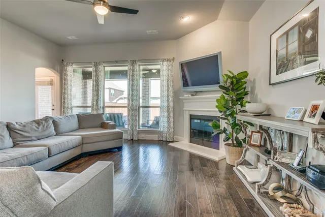 a living room with furniture a fireplace and a flat screen tv