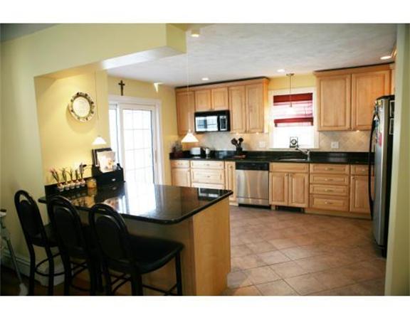 25 Barnes Street Waltham, MA 02453 - Photo 4 of 12 a kitchen with granite countertop sink stove and cabinets