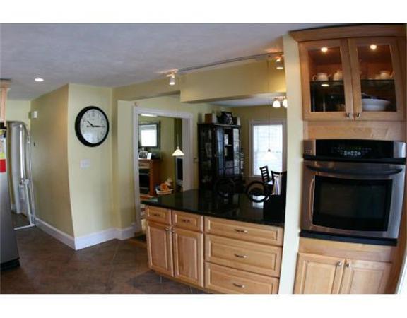 25 Barnes Street Waltham, MA 02453 - Photo 5 of 12 a kitchen with stainless steel appliances a stove and a refrigerator
