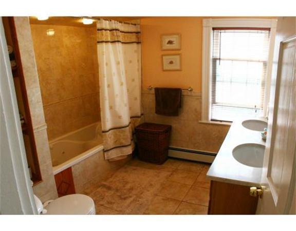 25 Barnes Street Waltham, MA 02453 - Photo 8 of 12 a bathroom with a sink a mirror and a shower