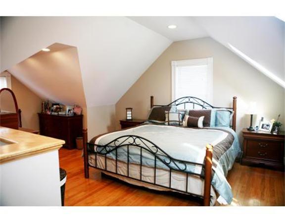 25 Barnes Street Waltham, MA 02453 - Photo 10 of 12 a bedroom with a bed and a dresser