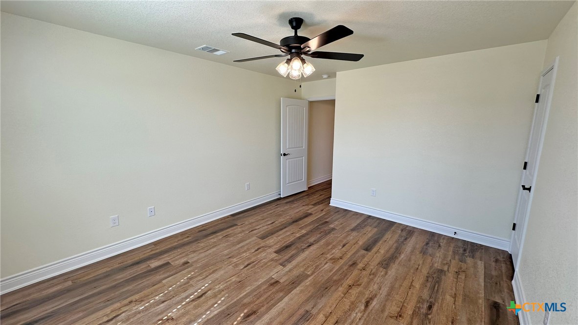 4237 Cool Basin Road Kempner, TX 76539 - Photo 22 of 36 a view of an empty room with wooden floor
