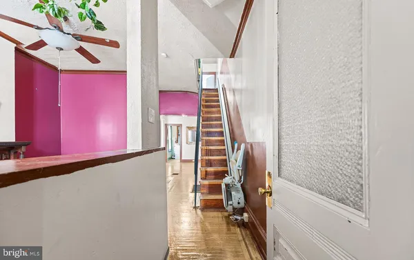 a view of a livingroom with furniture and staircase