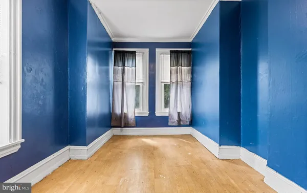 a view of a hallway with a window and a ceiling fan