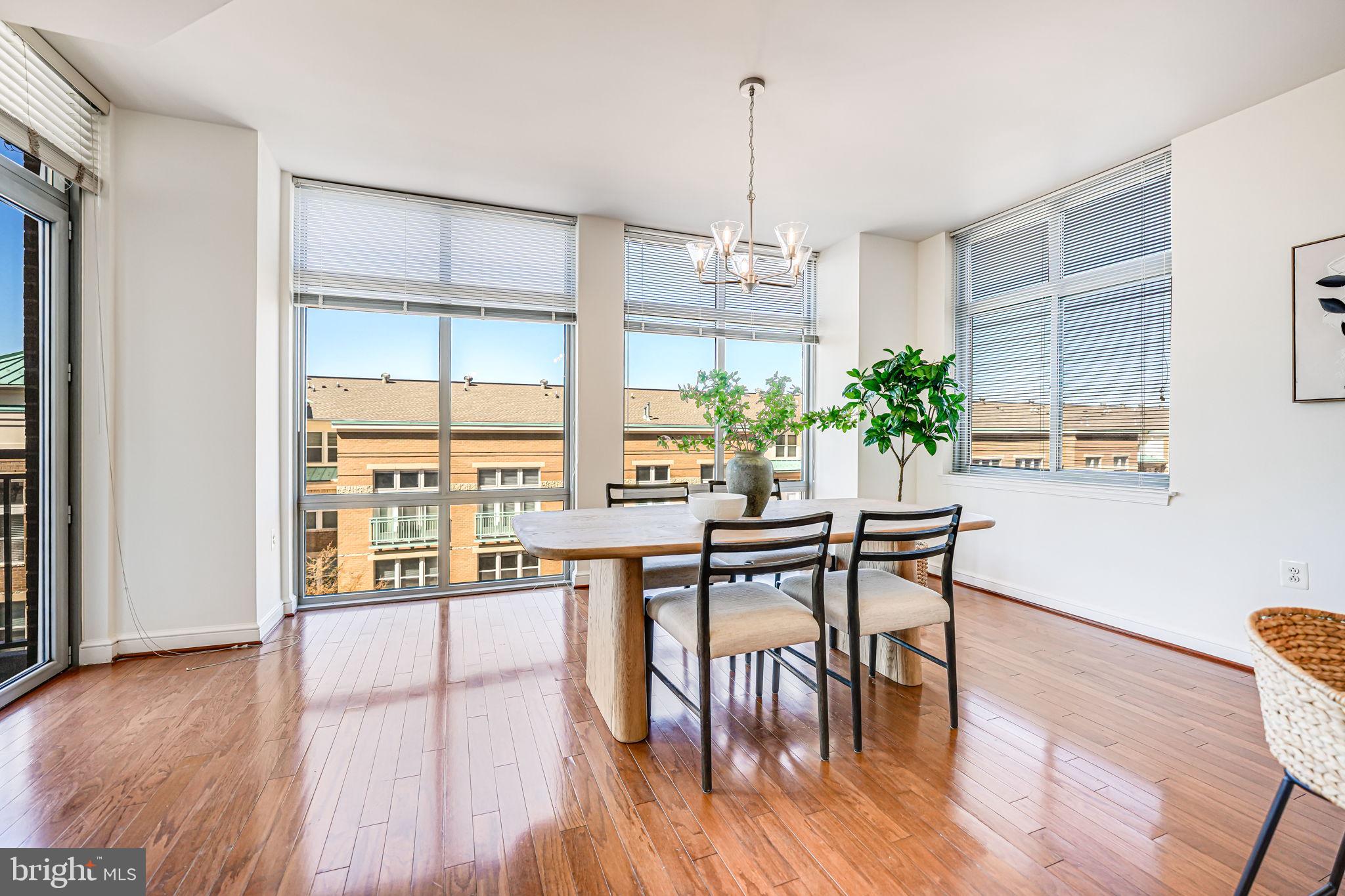 11990 Market Street, Unit 413 Reston, VA 20190 - Photo 15 of 82 a view of a dining room with furniture window and wooden floor