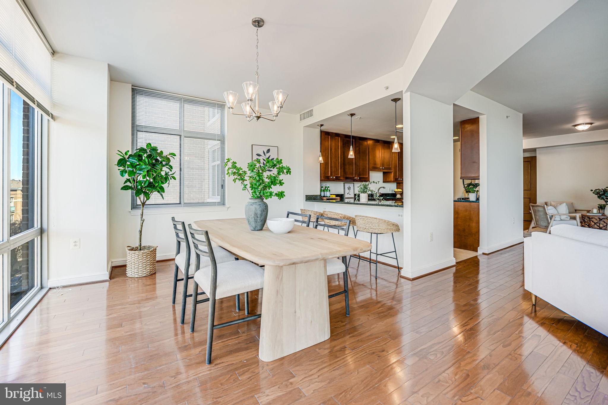 11990 Market Street, Unit 413 Reston, VA 20190 - Photo 16 of 82 a view of a dining room with furniture wooden floor and a chandelier