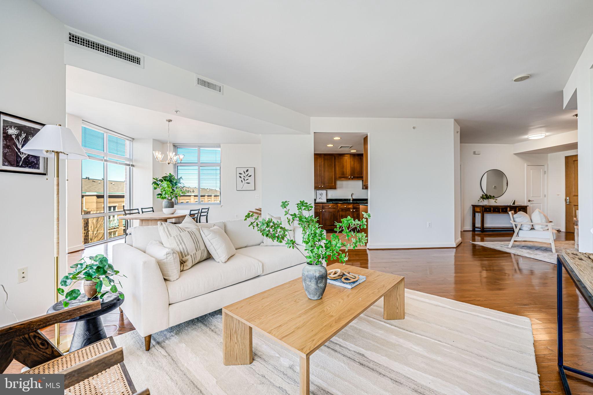 11990 Market Street, Unit 413 Reston, VA 20190 - Photo 19 of 82 a living room with furniture and a wooden floor