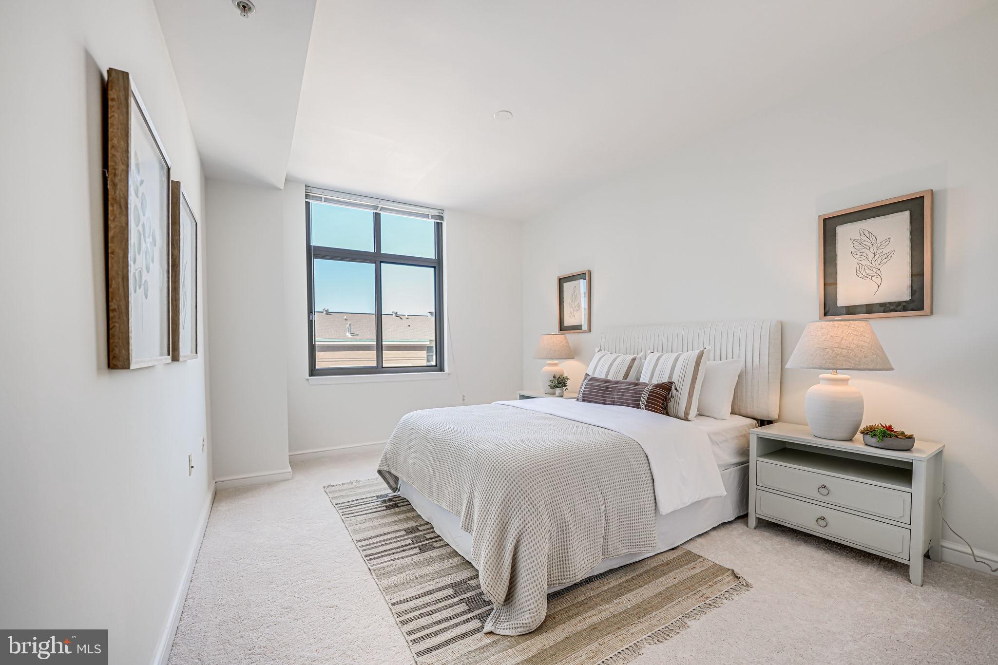 11990 Market Street, Unit 413 Reston, VA 20190 - Photo 21 of 82 a bedroom with a bed and a window