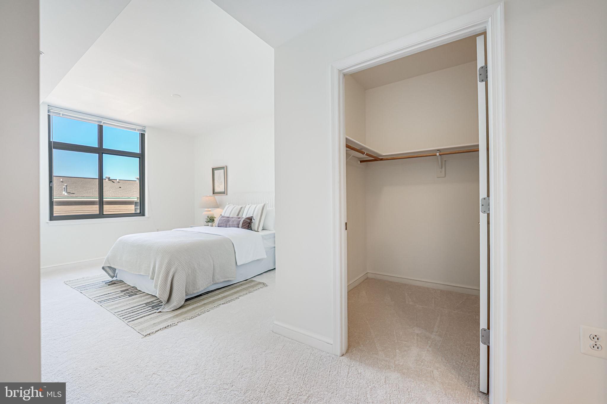 11990 Market Street, Unit 413 Reston, VA 20190 - Photo 22 of 82 a bedroom with a bed and a window