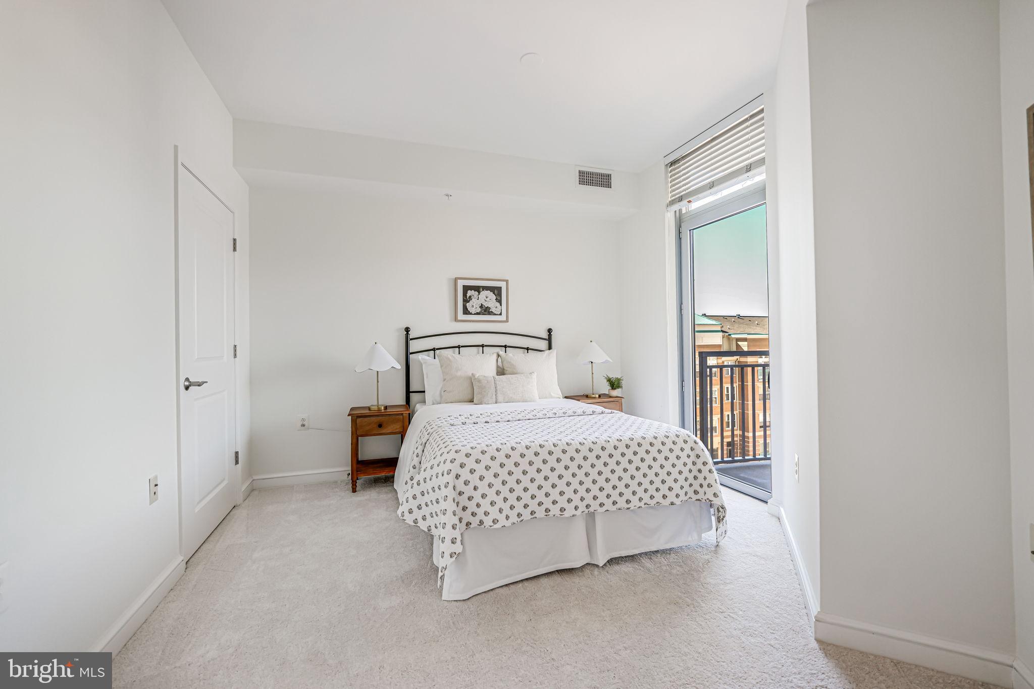 11990 Market Street, Unit 413 Reston, VA 20190 - Photo 26 of 82 a bedroom with a bed and a window