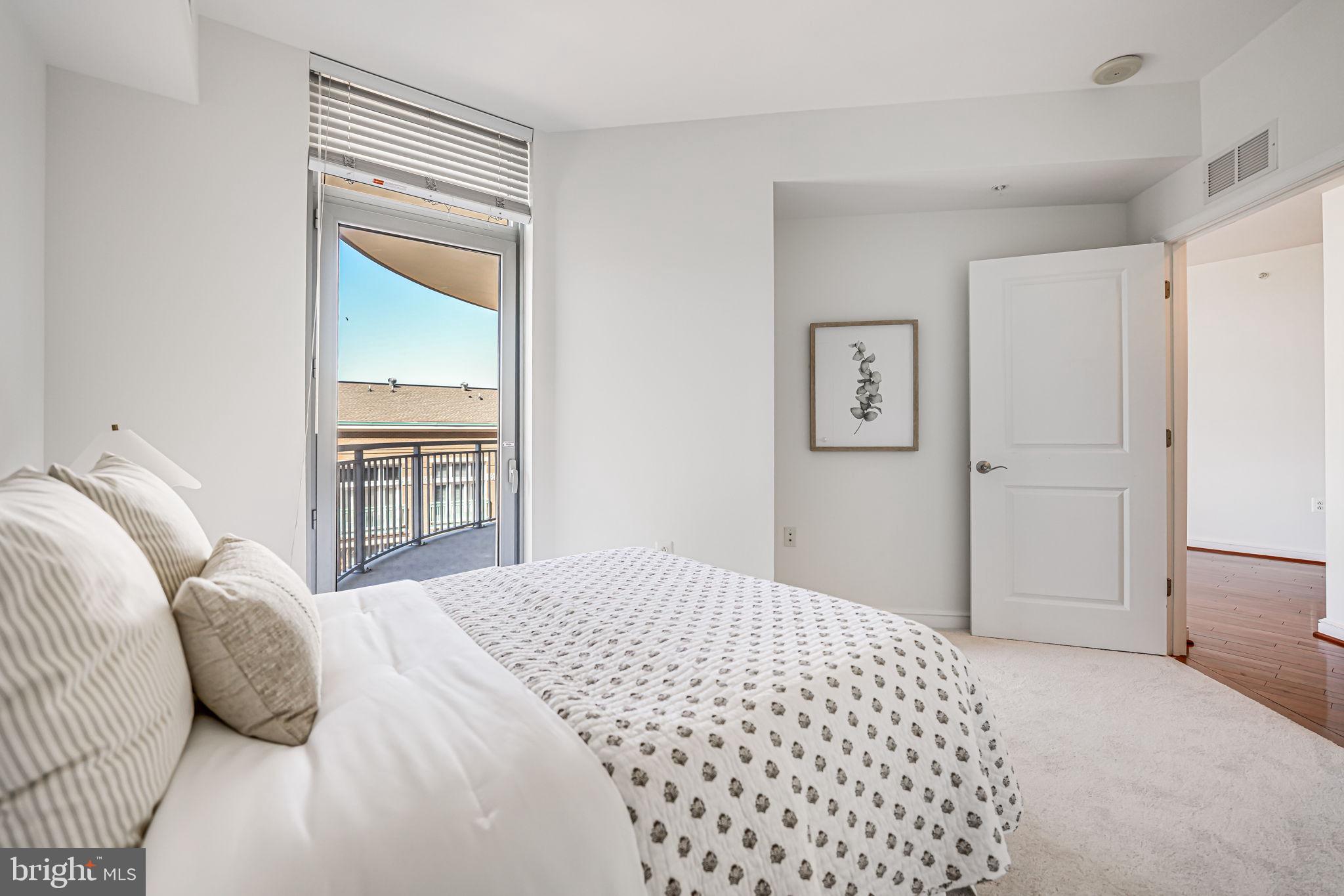 11990 Market Street, Unit 413 Reston, VA 20190 - Photo 27 of 82 a bedroom with a bed and a window