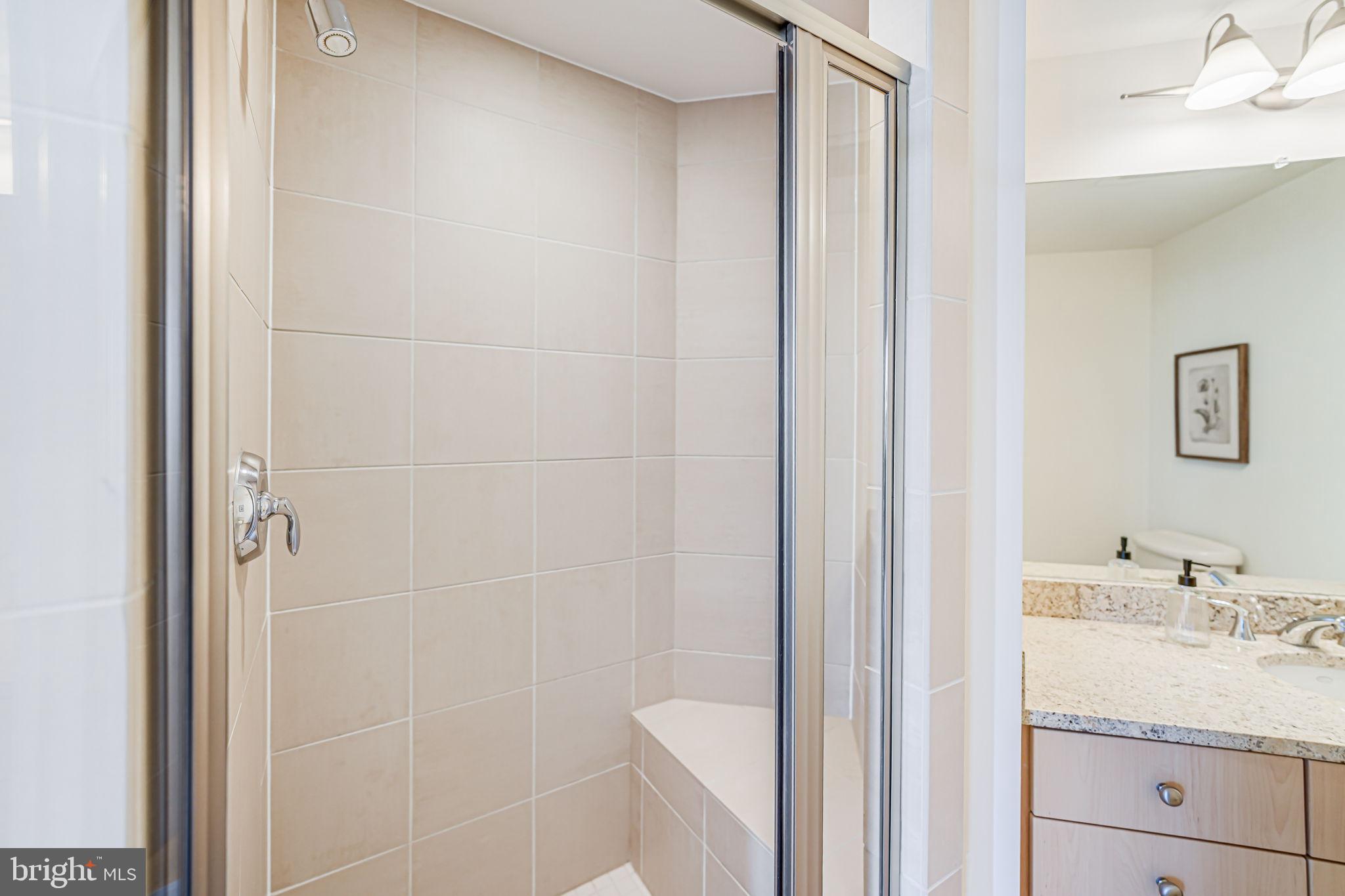 11990 Market Street, Unit 413 Reston, VA 20190 - Photo 31 of 82 a bathroom with a sink a toilet and shower