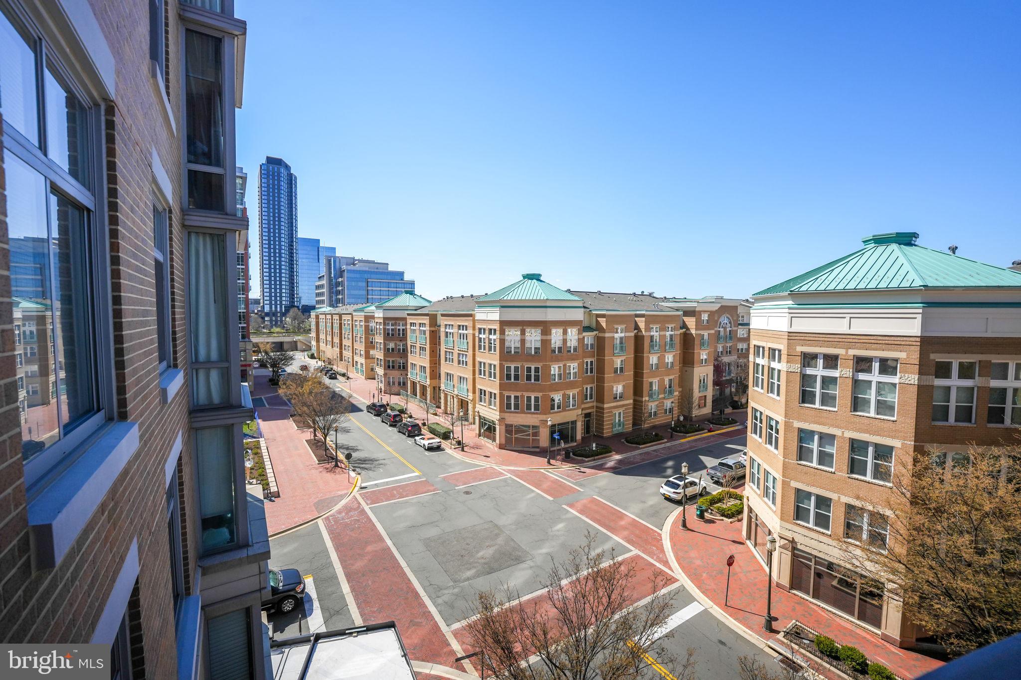 11990 Market Street, Unit 413 Reston, VA 20190 - Photo 37 of 82 a view of a balcony with chairs and wooden floor
