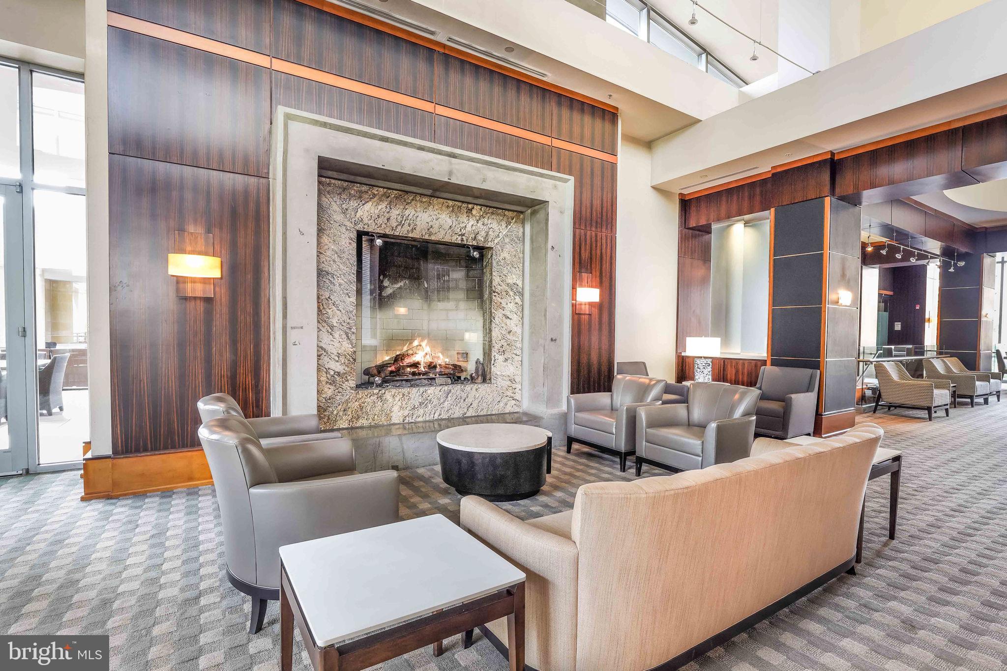 11990 Market Street, Unit 413 Reston, VA 20190 - Photo 46 of 82 a living room with furniture and a fireplace