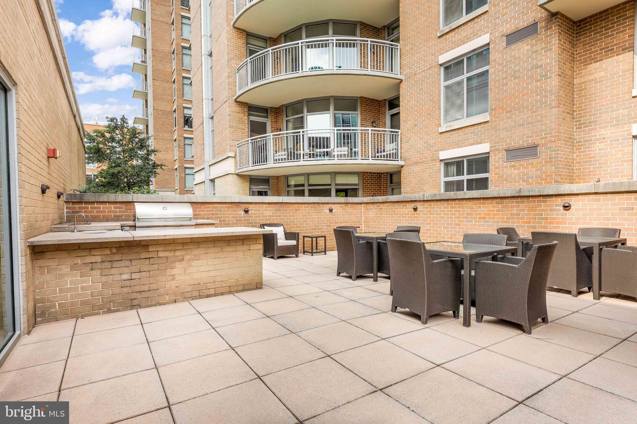11990 Market Street, Unit 413 Reston, VA 20190 - Photo 47 of 82 a view of a patio with a table and chairs