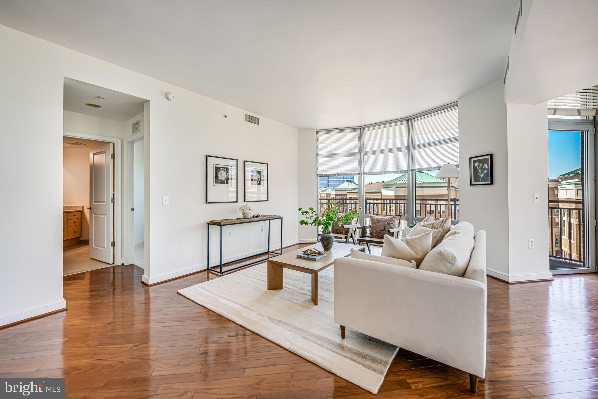11990 Market Street, Unit 413 Reston, VA 20190 - Photo 6 of 82 a living room with furniture and a table