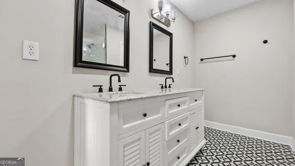 a bathroom with a double vanity sink and mirror