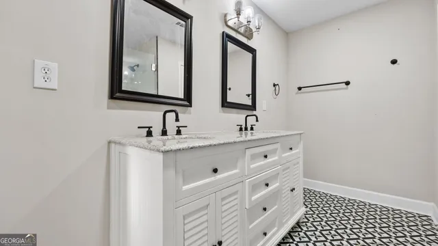 a bathroom with a double vanity sink and mirror