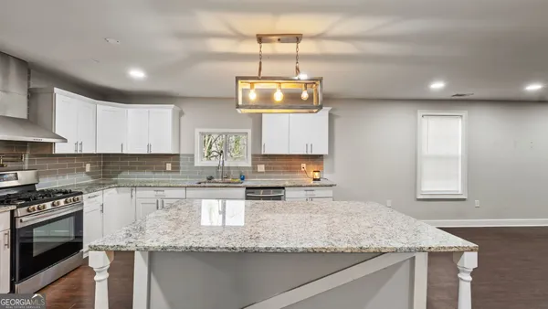 a kitchen with a sink stove and refrigerator