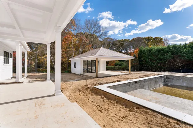 a view of a house with backyard and swimming pool
