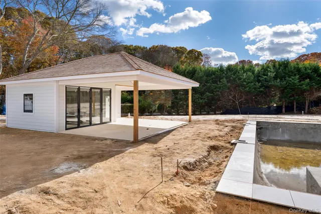 a view of swimming pool with palm trees
