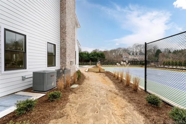 a view of house with swimming pool and sitting area