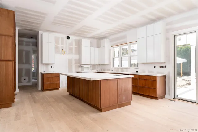 a large kitchen with stainless steel appliances kitchen island granite countertop a stove and a sink