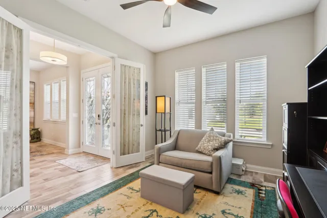 a kitchen with stainless steel appliances granite countertop a stove a sink a refrigerator and chairs