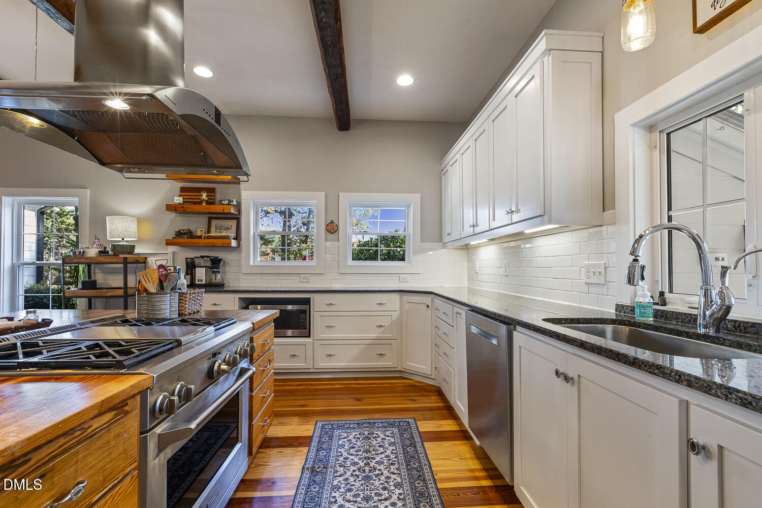 129 Kipling Road Fuquay-Varina, NC 27526 - Photo 11 of 58 a kitchen with stainless steel appliances granite countertop a stove and a sink
