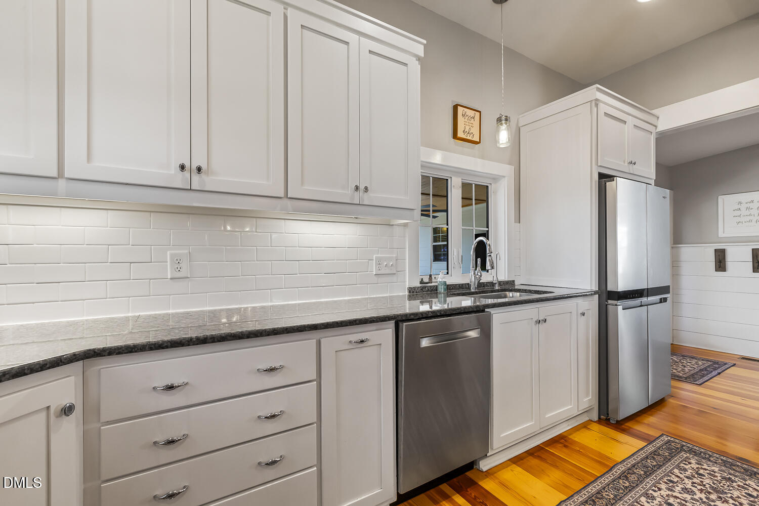 129 Kipling Road Fuquay-Varina, NC 27526 - Photo 15 of 58 a kitchen with stainless steel appliances granite countertop a refrigerator sink and white cabinets