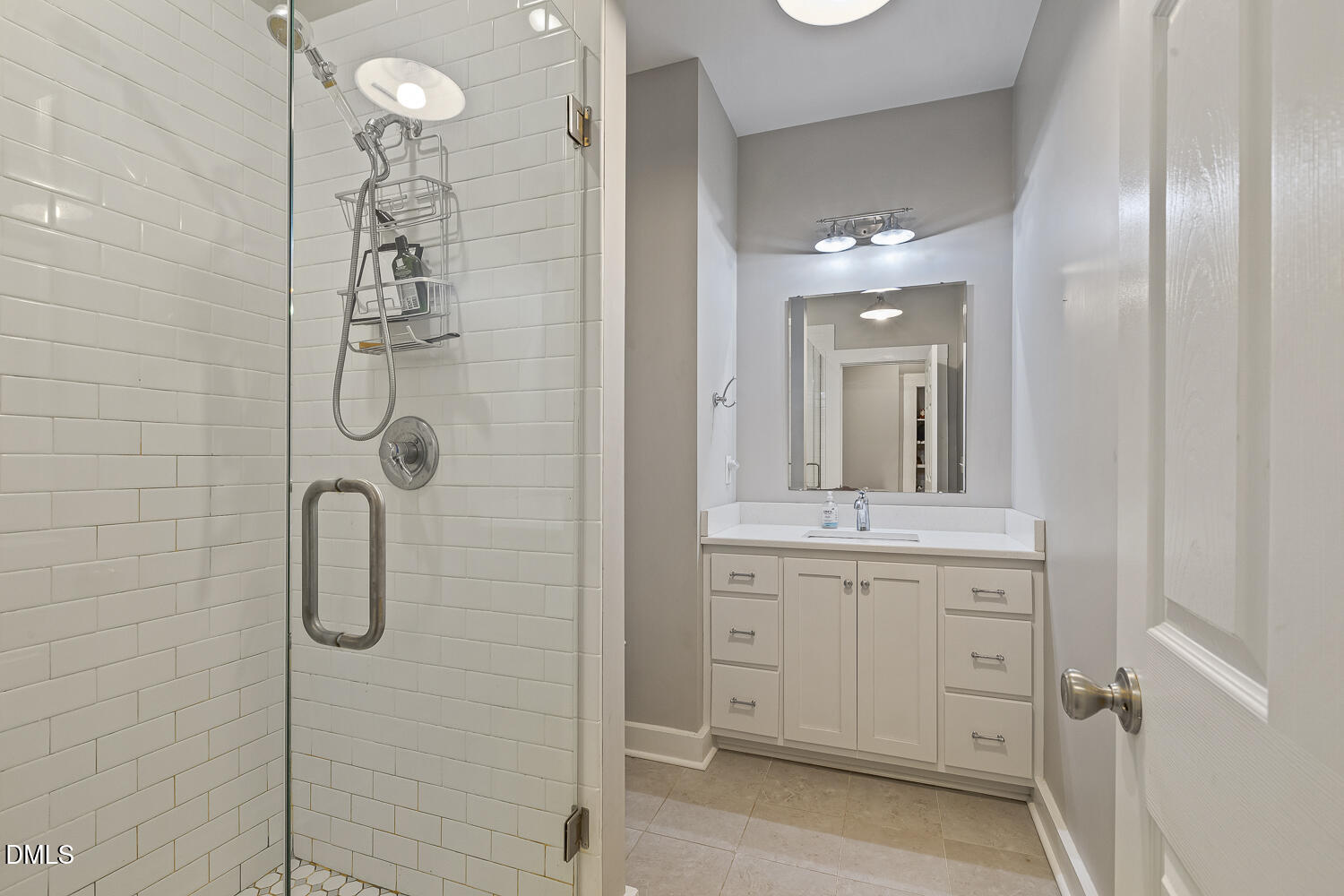 129 Kipling Road Fuquay-Varina, NC 27526 - Photo 28 of 58 a bathroom with a granite countertop sink a shower and a mirror