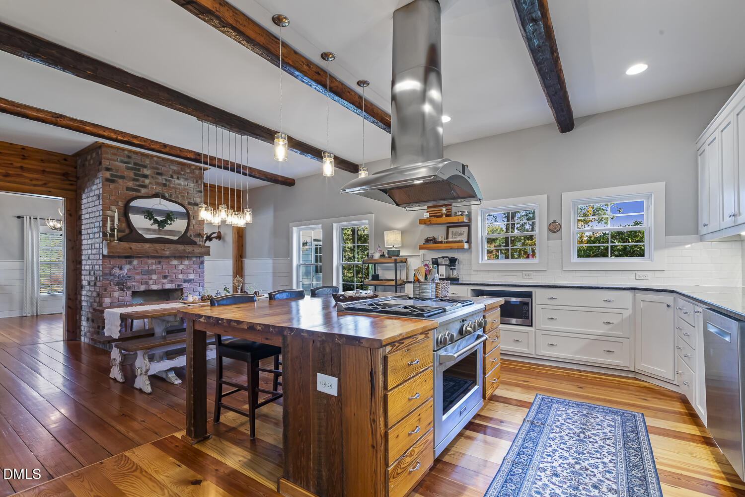 129 Kipling Road Fuquay-Varina, NC 27526 - Photo 10 of 58 a kitchen with stainless steel appliances a stove a chimney a sink and a center island