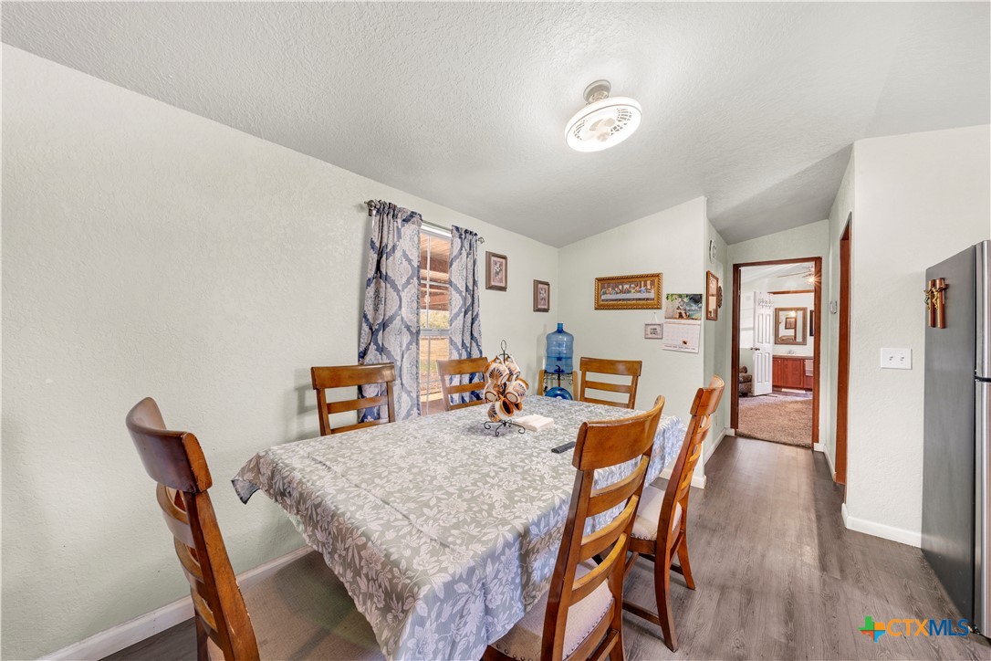 11706-11791 Kinney Road Atascosa, TX 78002 - Photo 19 of 25 a dining room with furniture and wooden floor