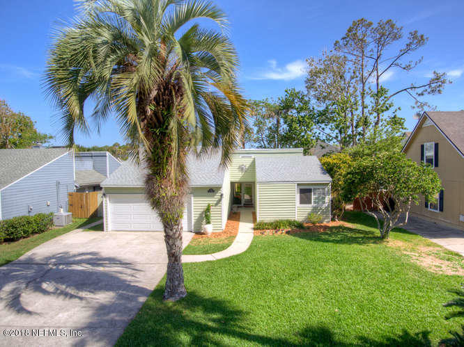 39 Solana Road Ponte Vedra Beach, FL 32082 - Photo 1 of 32 a view of a house with a yard and palm trees