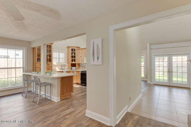 39 Solana Road Ponte Vedra Beach, FL 32082 - Photo 13 of 32 a view of a kitchen with dining table and chairs