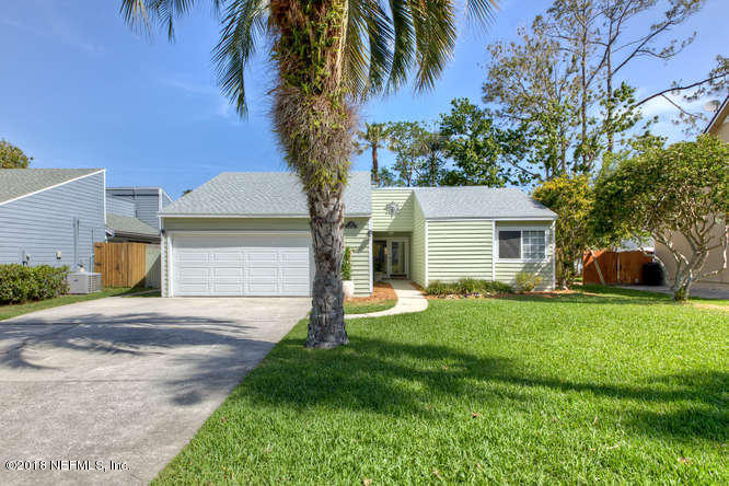39 Solana Road Ponte Vedra Beach, FL 32082 - Photo 2 of 32 a front view of a house with a garden and yard