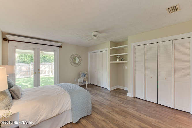 39 Solana Road Ponte Vedra Beach, FL 32082 - Photo 22 of 32 a bedroom with a large bed and wooden floor