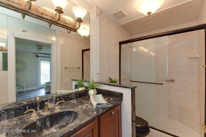 39 Solana Road Ponte Vedra Beach, FL 32082 - Photo 24 of 32 a bathroom with a sink and a mirror
