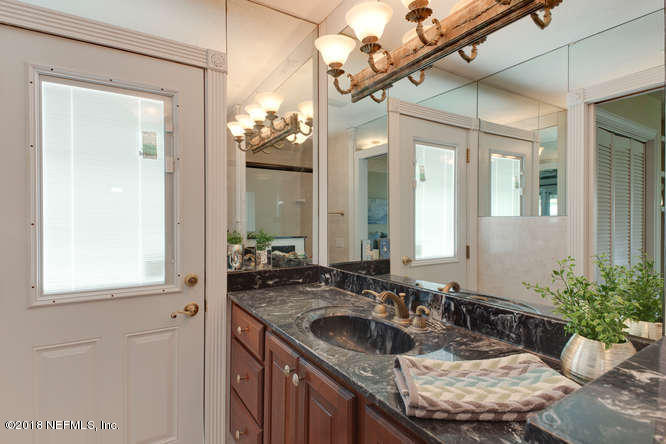 39 Solana Road Ponte Vedra Beach, FL 32082 - Photo 25 of 32 a bathroom with a granite countertop sink a large mirror and a shower