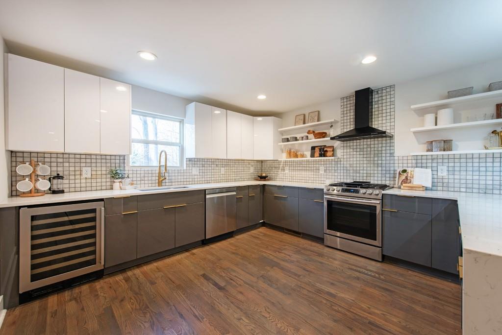 331 Eleanor Street Southeast Atlanta, GA 30317 - Photo 14 of 50 a large kitchen with stainless steel appliances granite countertop a stove sink and cabinets