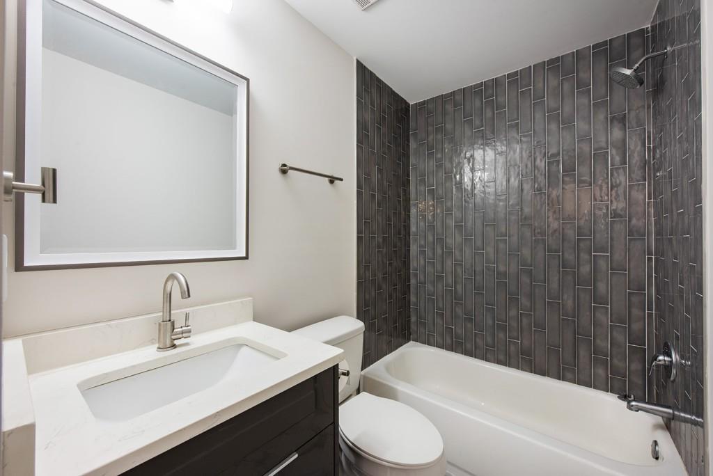 331 Eleanor Street Southeast Atlanta, GA 30317 - Photo 22 of 50 a bathroom with a sink a toilet and shower