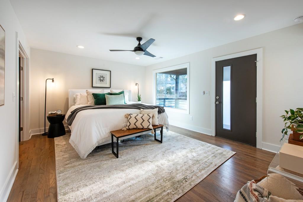 331 Eleanor Street Southeast Atlanta, GA 30317 - Photo 24 of 50 a bedroom with a bed lamps and wooden floor