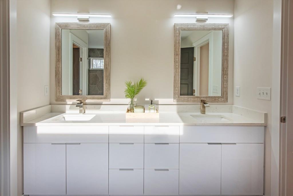 331 Eleanor Street Southeast Atlanta, GA 30317 - Photo 32 of 50 a bathroom with double sink and a mirror