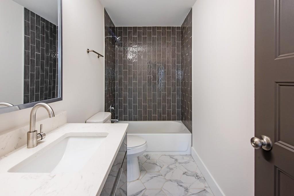 331 Eleanor Street Southeast Atlanta, GA 30317 - Photo 36 of 50 a bathroom with a sink a toilet and shower