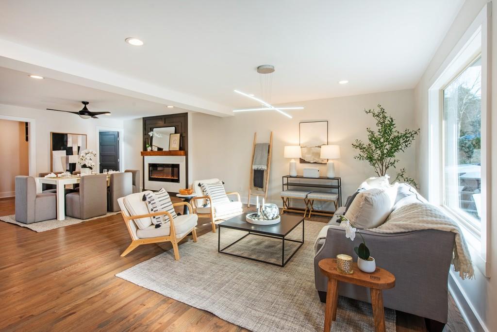 331 Eleanor Street Southeast Atlanta, GA 30317 - Photo 7 of 50 a living room with furniture couches and a dining table with wooden floor