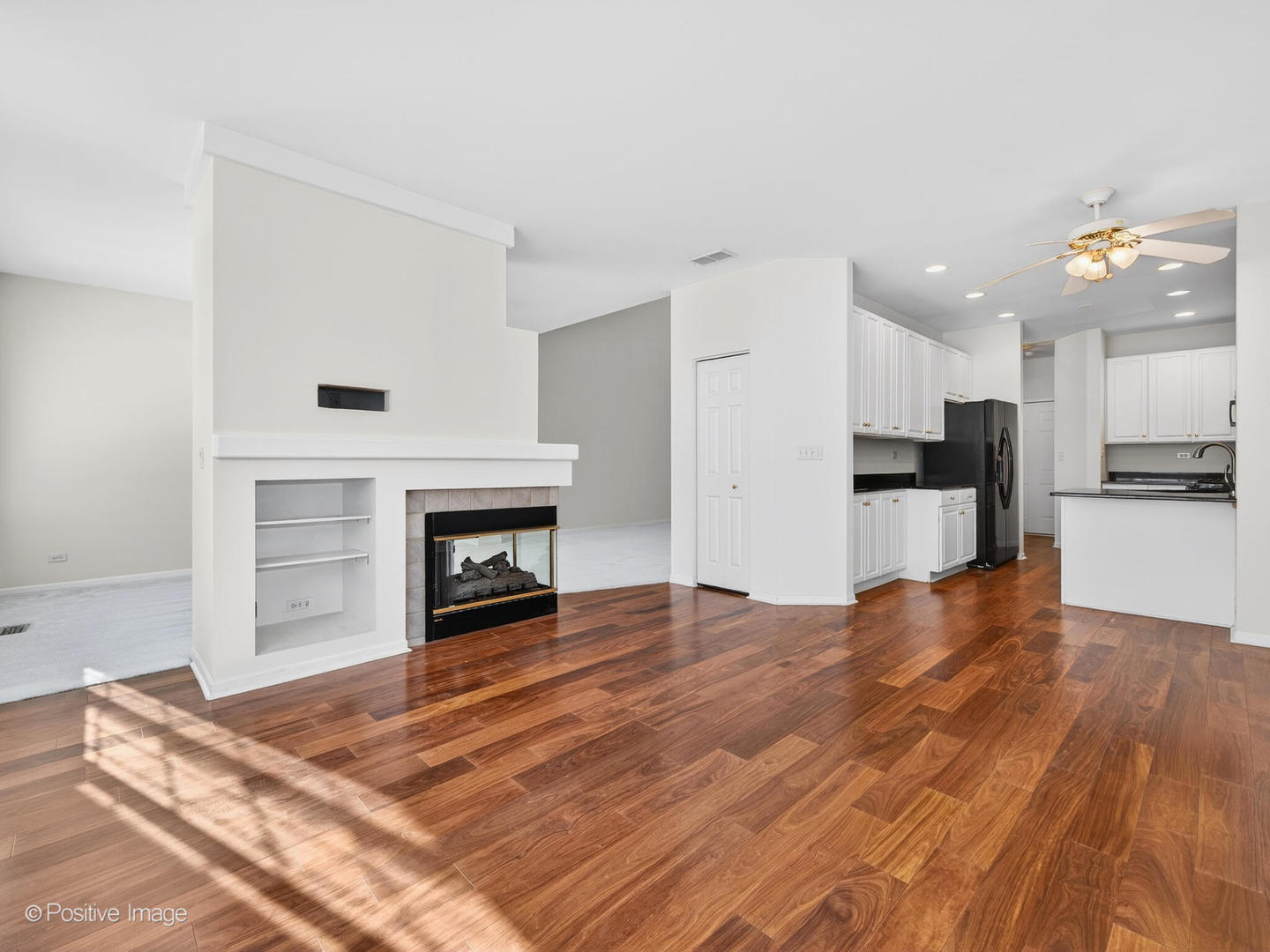 31104 Carpenter Court Warrenville, IL 60555 - Photo 11 of 32 a view of kitchen and empty room with wooden floor